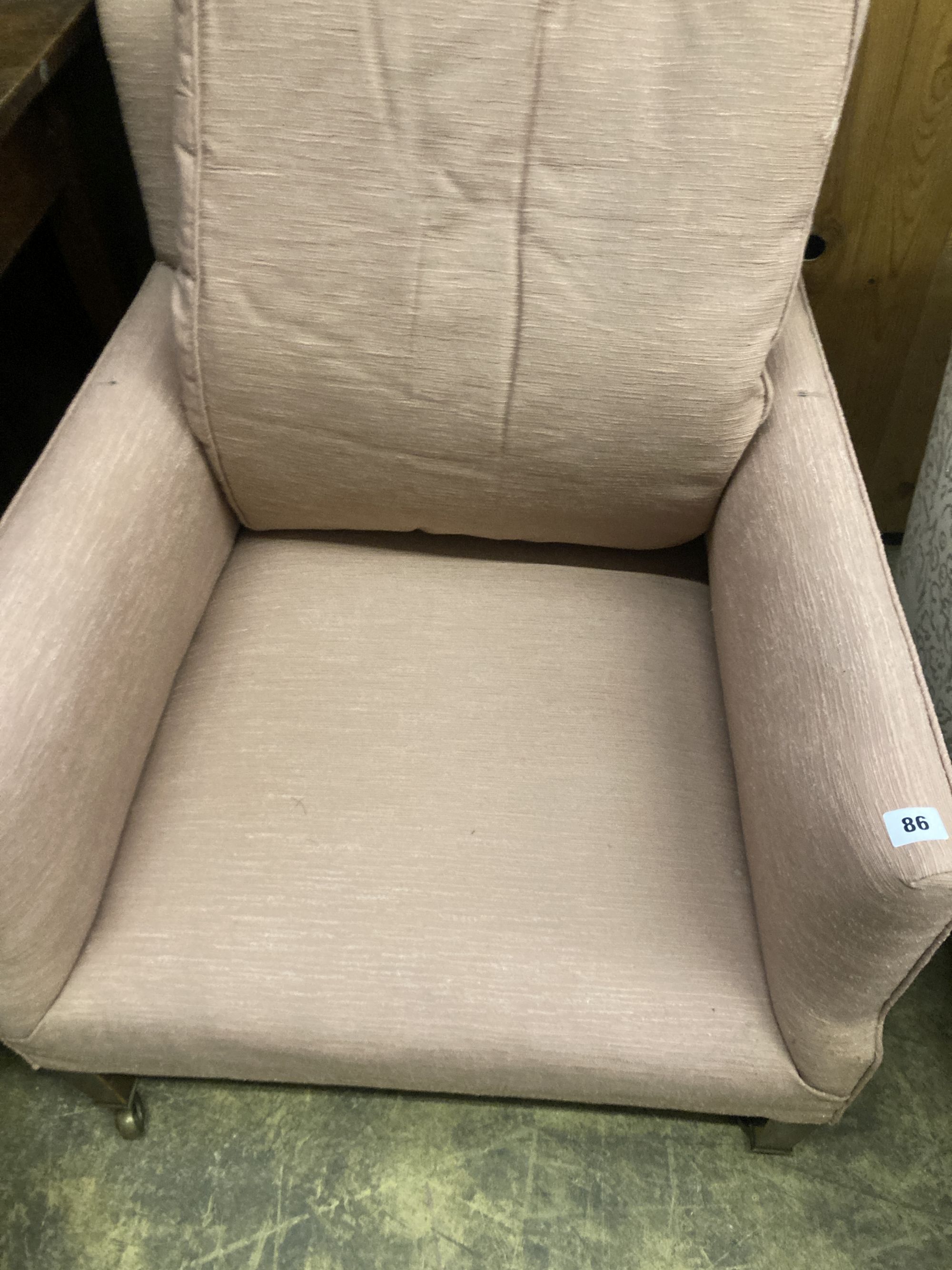 A pair of Edwardian Howard & Son upholstered square framed armchairs with stamped legs and casters, width 69cm, depth 70cm, height 78cm